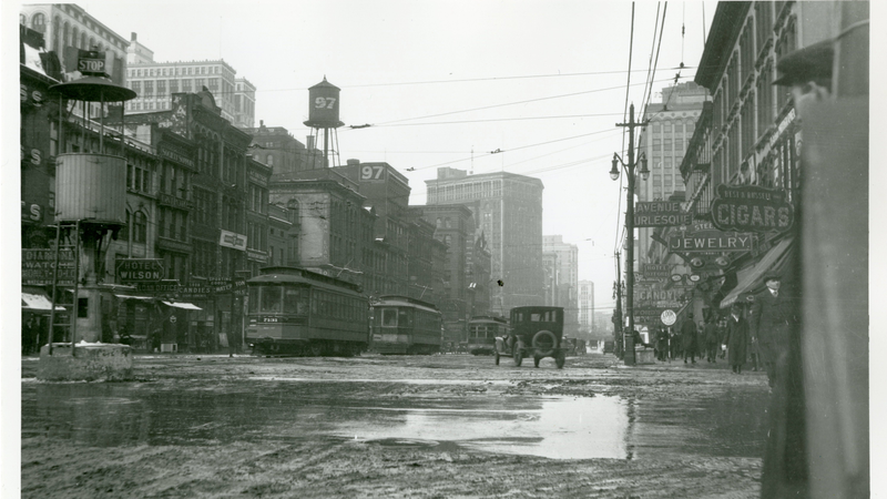 A downtown Detroit intersection in 1915, with a crow’s nest-style traffic stand that’s topped with a stop sign, via Detroit Historical Society